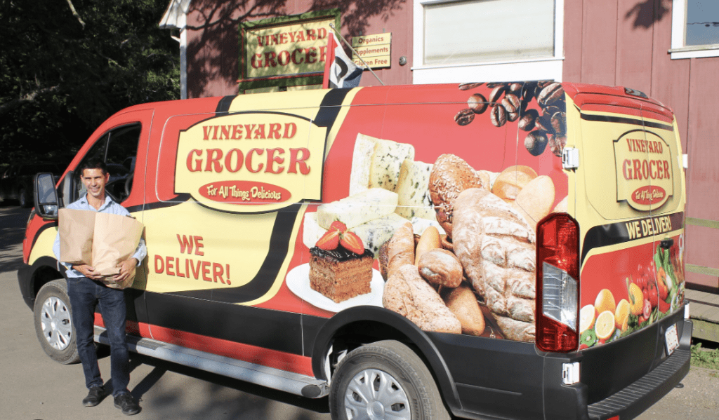 Grocery truck delivery with Vineyard Grocer logo and marketing all on it. 